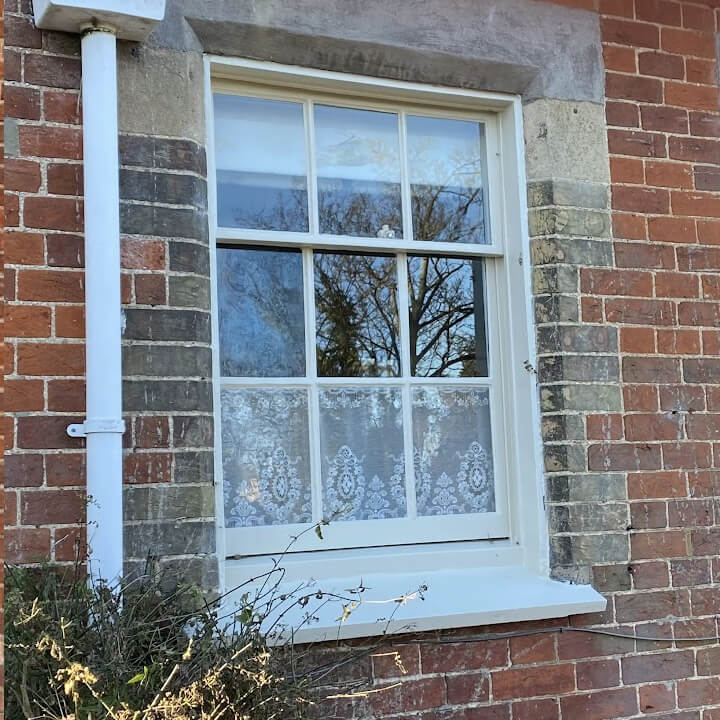 Georgian style sash window with glazing bars after double glazing