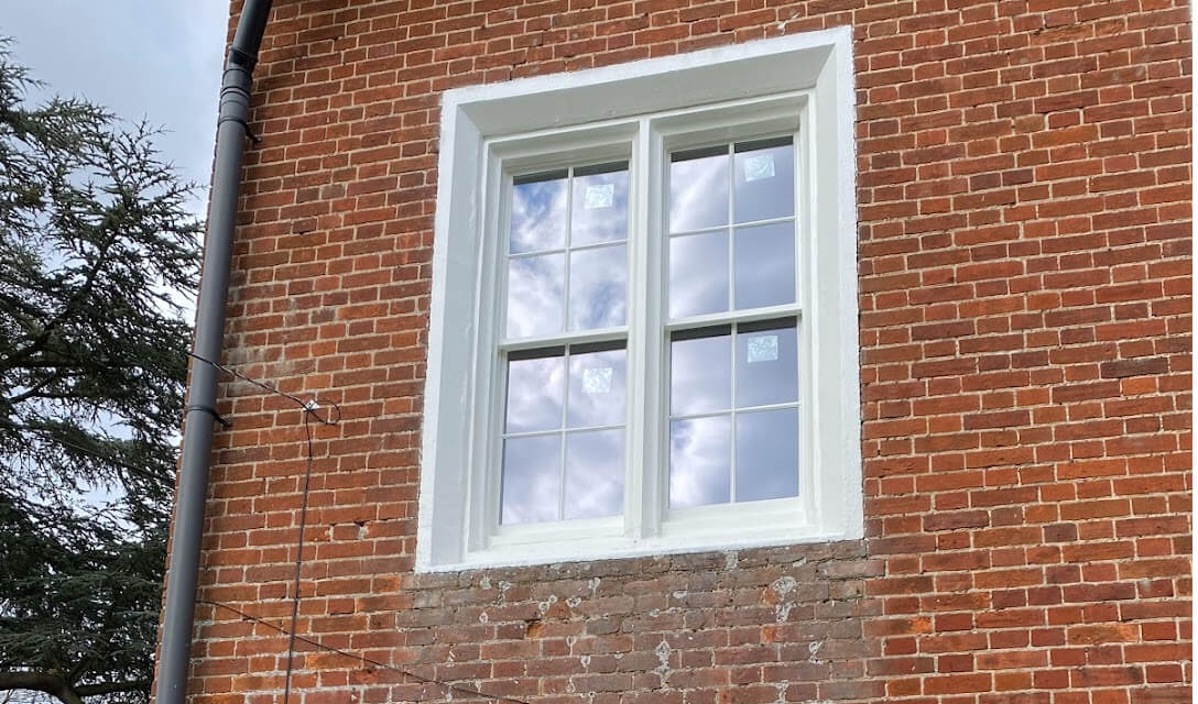 Sash window with Georgian glazing bars in a brick wall