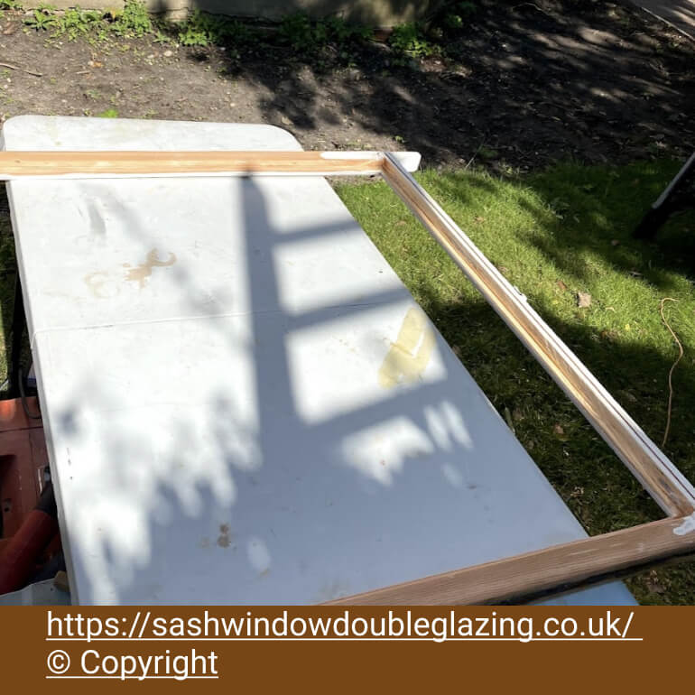 Sash on the bench outside with the glazing rebate being cut