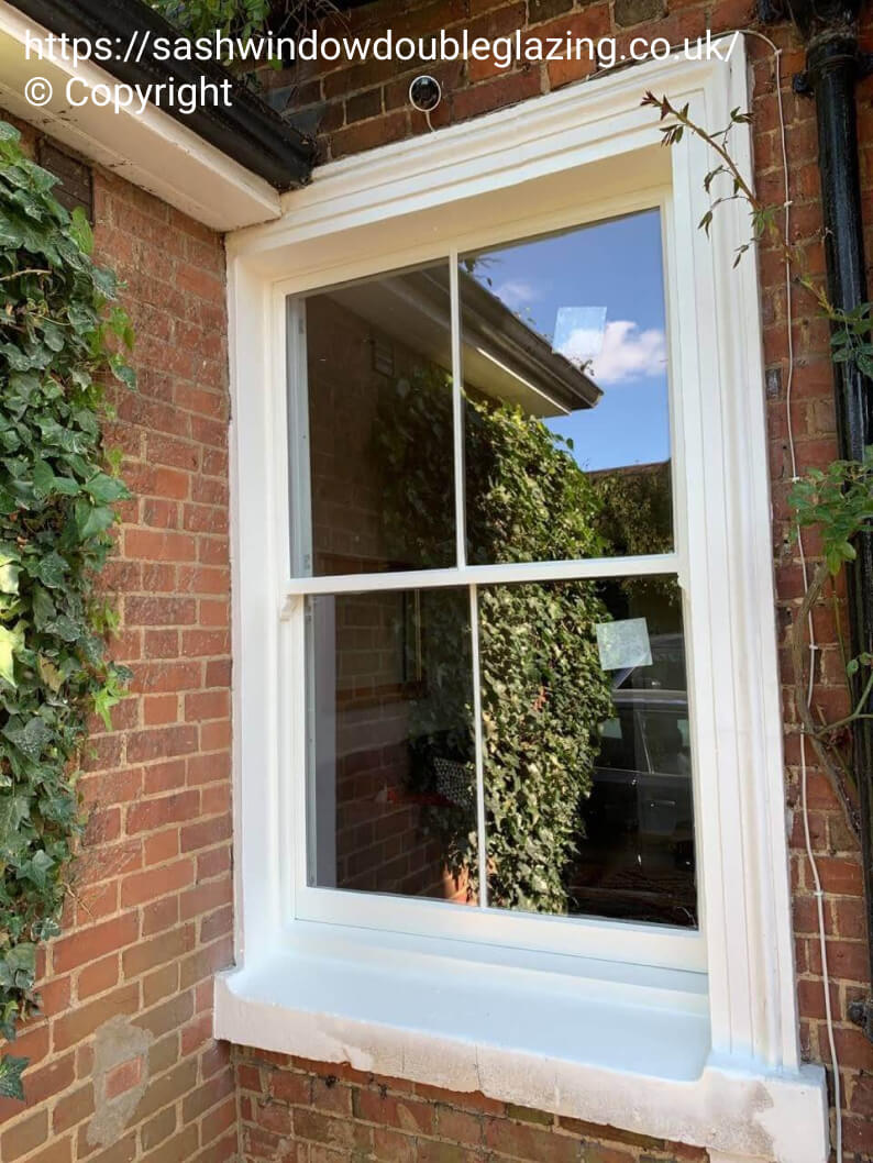 Two-over-two sash window after reglazing with slimline vacuum double glazing