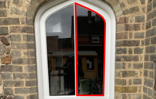 Pointed Gothic arch window in stone with the arched pane outlined