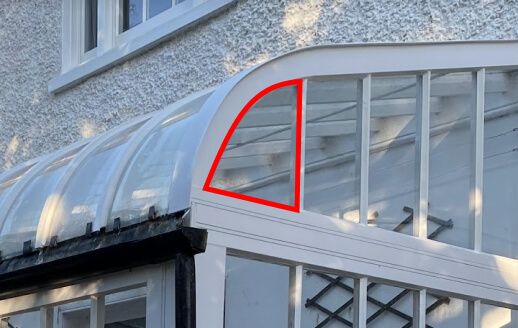 Curved-headed pane in a bay window outlined in red